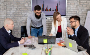 Business owner reviewing marketing plans from multiple agencies